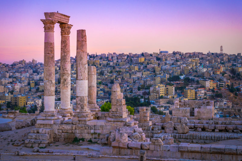 The columns of the Citadel of Amman, Jordan stand basking in the glow of the sunset. 