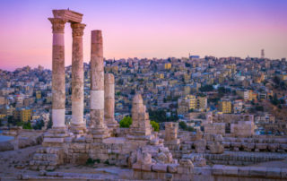 The columns of the Citadel of Amman, Jordan stand basking in the glow of the sunset.
